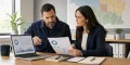 Restoration company owner and marketing strategist reviewing lead quality beside a service-area map